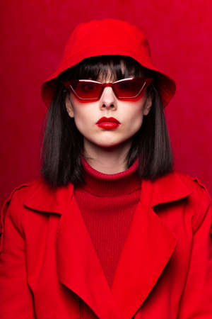 beautiful girl in red glasses, single color, closeup portraitの写真素材