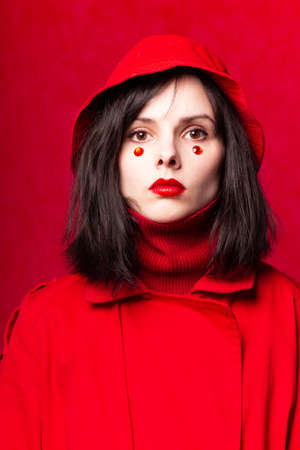 young woman on a red backgroundの写真素材