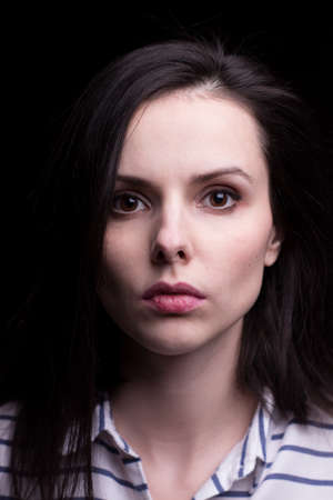 woman in a striped shirt on a black background