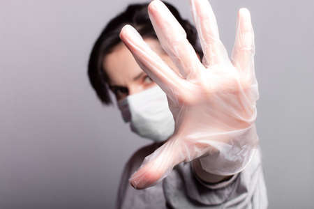 woman in medical mask and gloves fights the virus, health careの写真素材