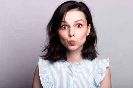 beautiful woman in a blue blouse, close-up portraitの写真素材