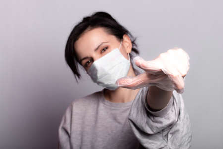 woman in medical mask and gloves fights the virus, health careの写真素材