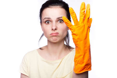 A woman in orange cleaning gloves on whiteの写真素材