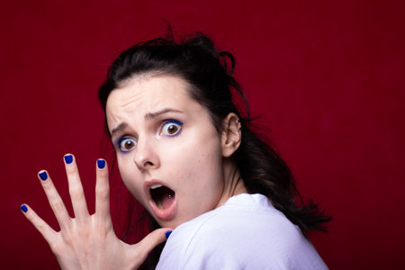 woman in white t-shirt on red backgroundの写真素材