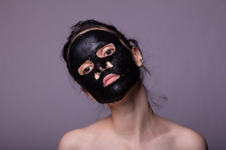 woman in black cloth mask on face, cosmetic skin careの写真素材