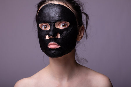 woman in black cloth mask on face, cosmetic skin careの写真素材