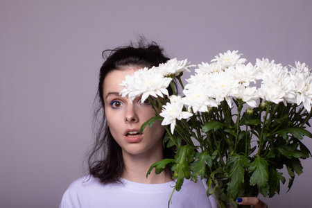 woman in love and holding a large bouquet of flowersの写真素材