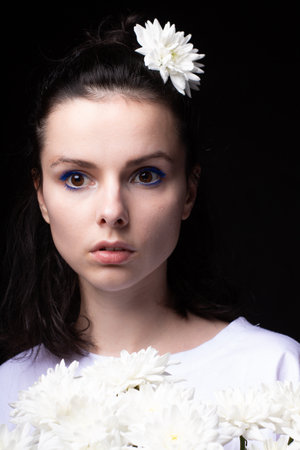 woman with a bouquet of chrysanthemums on a black backgroundの写真素材