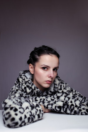 woman in leopard sweatshirt, gray backgroundの写真素材