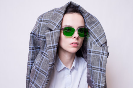 businesswoman in a suit and green glassesの写真素材