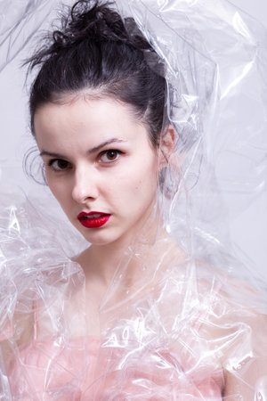woman with red lips wrapped in plastic wrap. high quality photoの写真素材