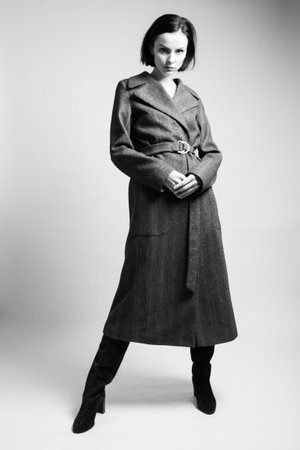 beautiful woman in a coat and boots in full growth. high quality photoの写真素材