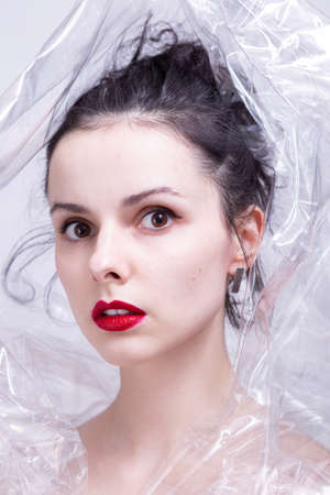 woman with red lips wrapped in plastic wrap. high quality photoの写真素材