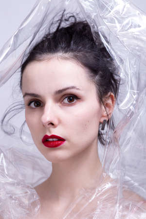 woman with red lips wrapped in plastic wrap. high quality photoの写真素材