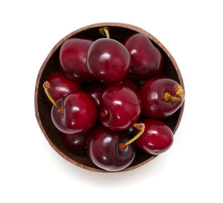 cherry in a bowl isolated on white, top viewの写真素材