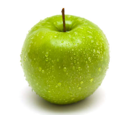 green apple with water drops close up on white backgroundの写真素材