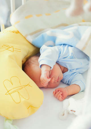 newborn sleeping in his cribの写真素材