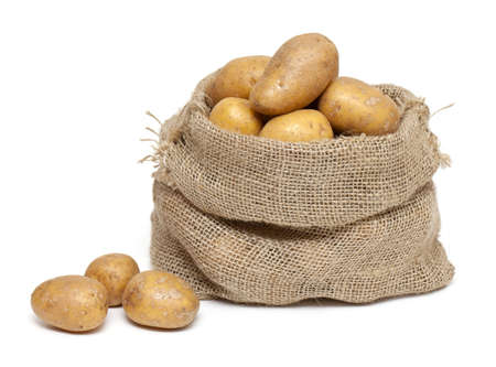 potatoes in burlap bag isolated on white backgroundの写真素材