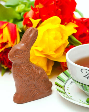 Easter chocolate bunny, tulips and teaの写真素材