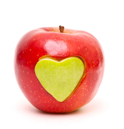 red apple and  heart shape cut and inserted isolated on whiteの写真素材