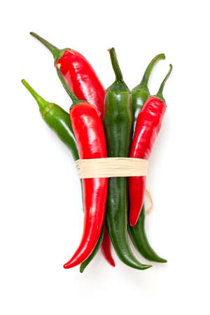 tied red and green pepperoni isolated on whiteの写真素材