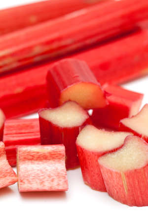 freshly cut stems of rhubarb on a white backgroundの写真素材