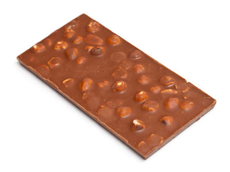 milk chocolate with hazelnuts isolated on whiteの写真素材