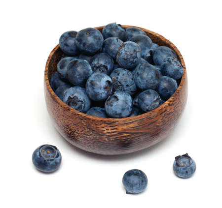 bowl full of blueberries isolated on whiteの写真素材
