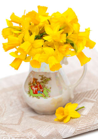 narcissus flowers in vase isolated on whiteの写真素材