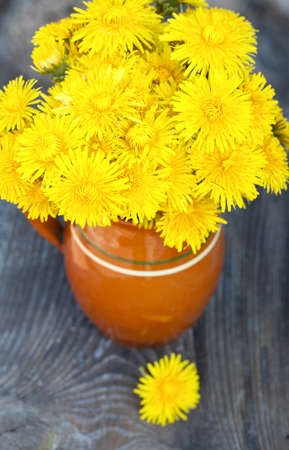 bouquet of dandelions on wooden tableの写真素材
