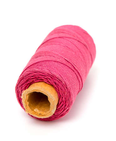 red thread bobin over white