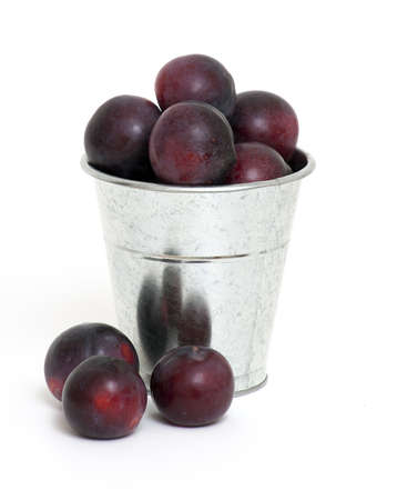 bucket with plums isolatedの写真素材