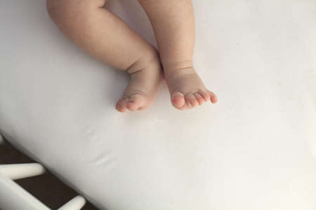 baby legs in a crib