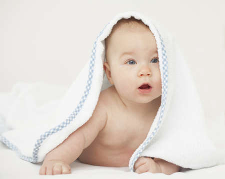 baby boy looking from under towel