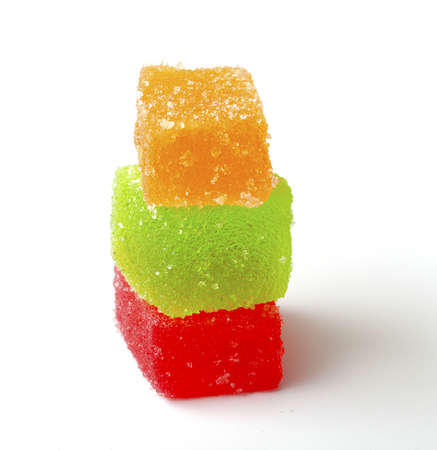stack of jelly fruit candies on white backrgound