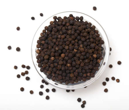 black pepper in glass bowl on white, top view