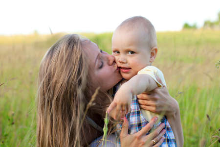 mother and child on summer fieldの写真素材