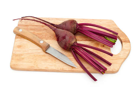 beet root on cutting board over whiteの写真素材