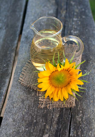 sunflower and sunflower oil on wooden tableの写真素材