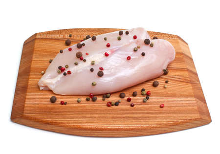 fresh raw chicken breast on cutting boardの写真素材