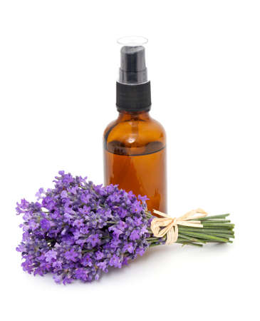 bottle of lavender oil and bunch of lavender flowersの写真素材