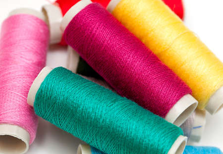 bobbins of thread close up over white