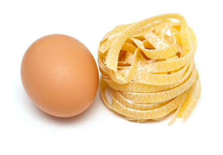 fettuccine pasta and fresh egg isolated on white backgroundの写真素材