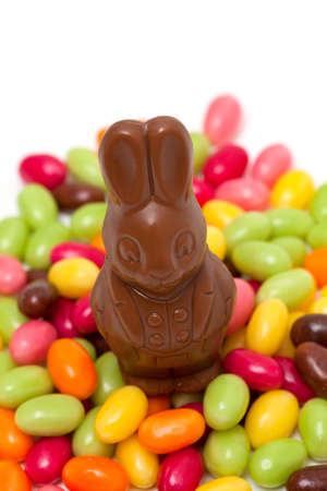chocolate bunny and colorful candies isolated on white background