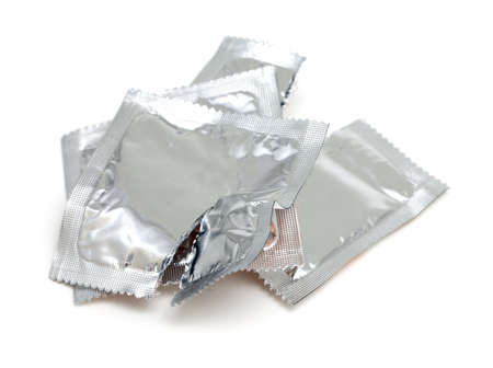 open packs of condoms isolated on white backgroundの写真素材