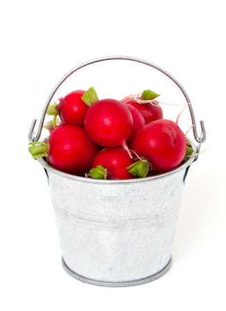 fresh radish in a bucket isolated on white backgroundの写真素材