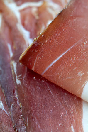 cured ham isolated on white backgroundの写真素材