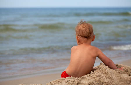 cute boy having fun on beachの写真素材