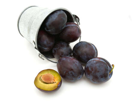 plums in a bucket over whiteの写真素材
