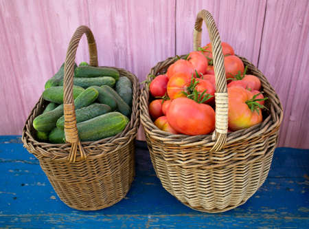 baskets with cucumbers and tomatoesの写真素材